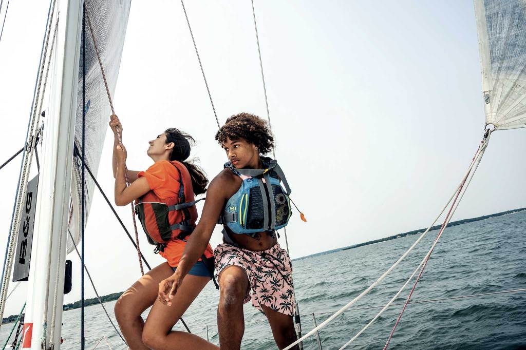 Young sailors sailing on the water