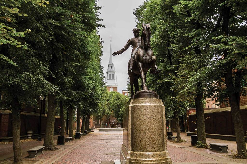 Statue of Paul Revere in Boston's northend with the old north church in the background