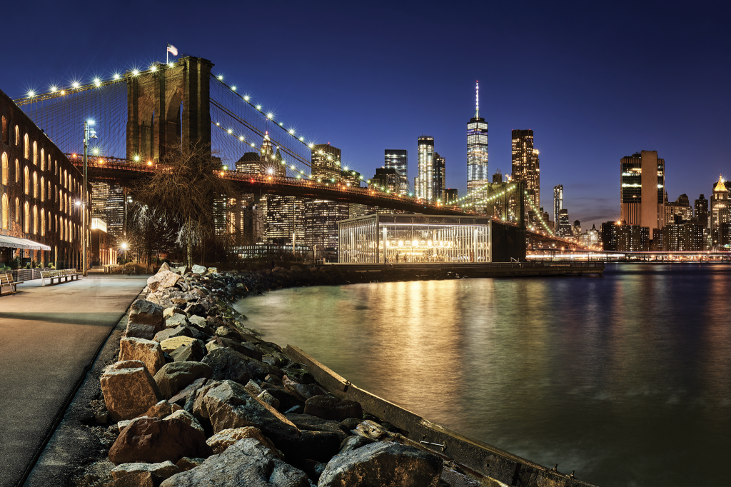 New York harbor bridge in the evening sky with lights