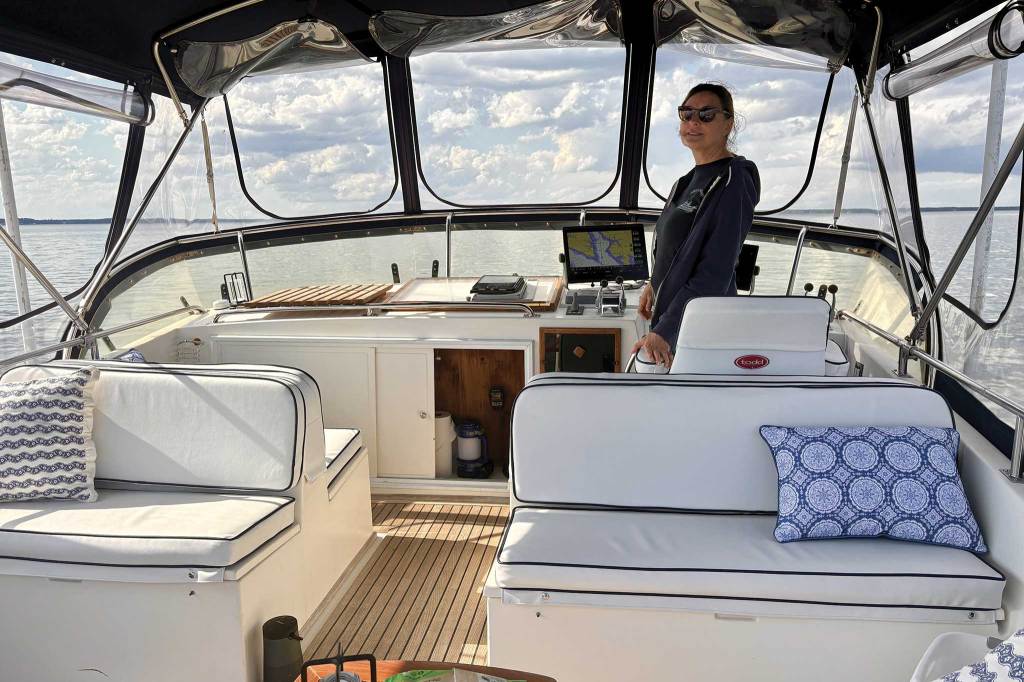 A woman at the bridge of a boat