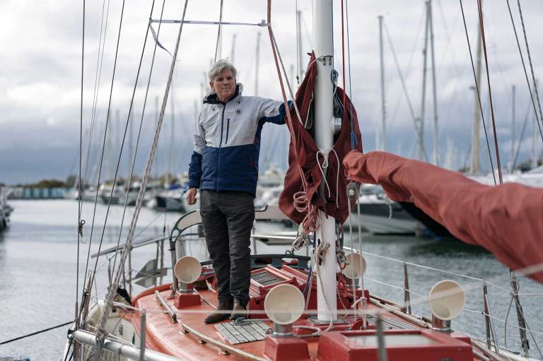 JL108592-ggr-2608 Sailboat docked with a man standing at the mast
