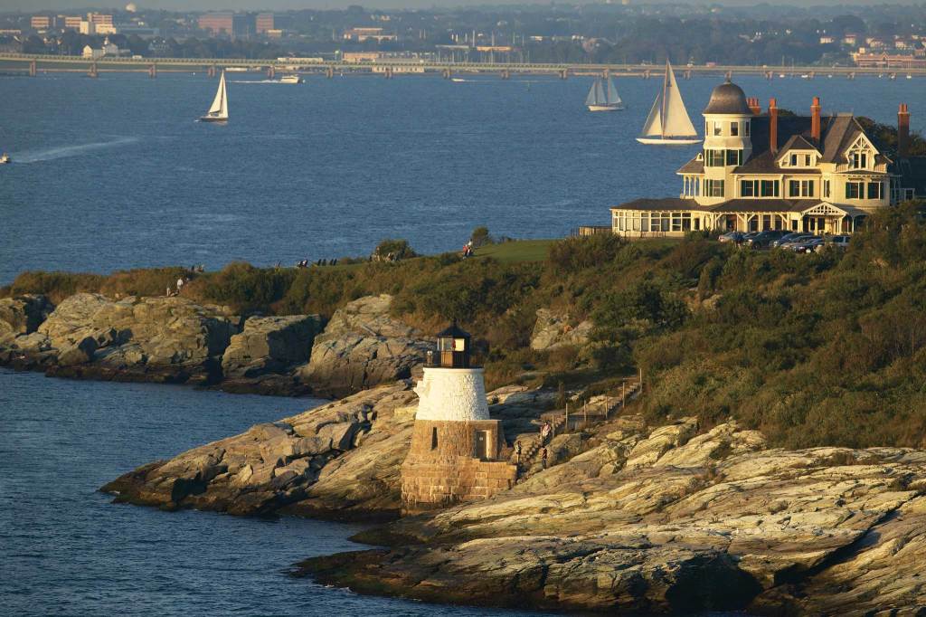 Beautiful coastline with a lighthouse in view and a mansion